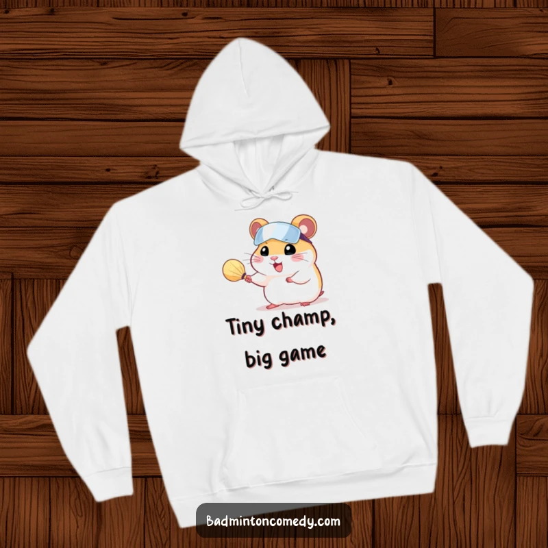 Funny, cheerful hamster wearing a visor, serving a shuttlecock with a badminton racket, on a cozy hoodie.