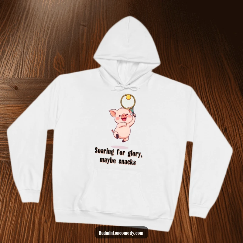 Funny Piglet Badminton Hoodie: A gleeful piglet jumping with a badminton racket, embodying joyful and energetic sports fun.