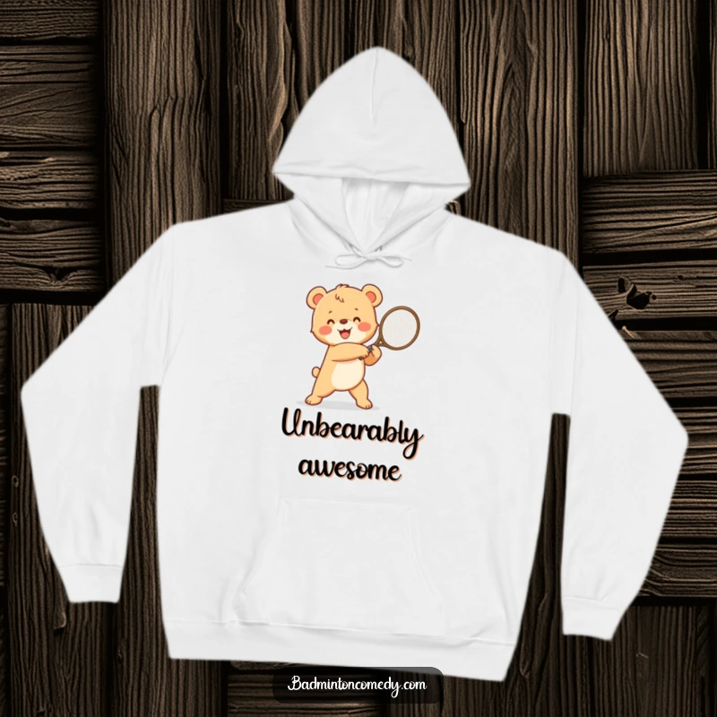 Funny happy bear cub in a winning pose, triumphantly swinging a tennis racket, a cozy and humorous hoodie design.