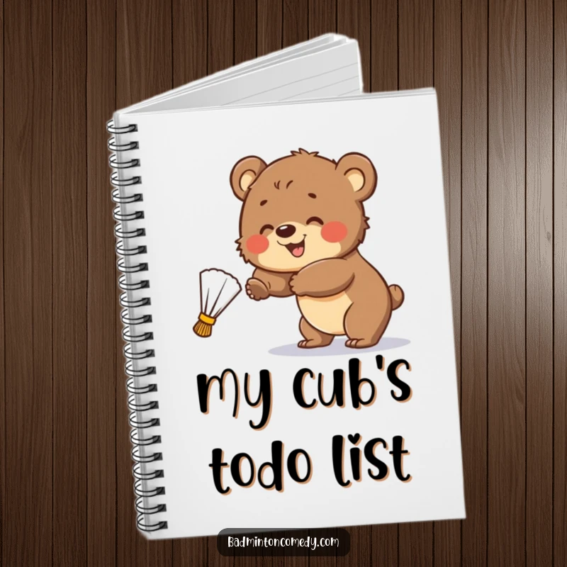 Funny Notebook: A smiling bear cub attempts to hit a badminton shuttlecock, perfect for jotting down thoughts.