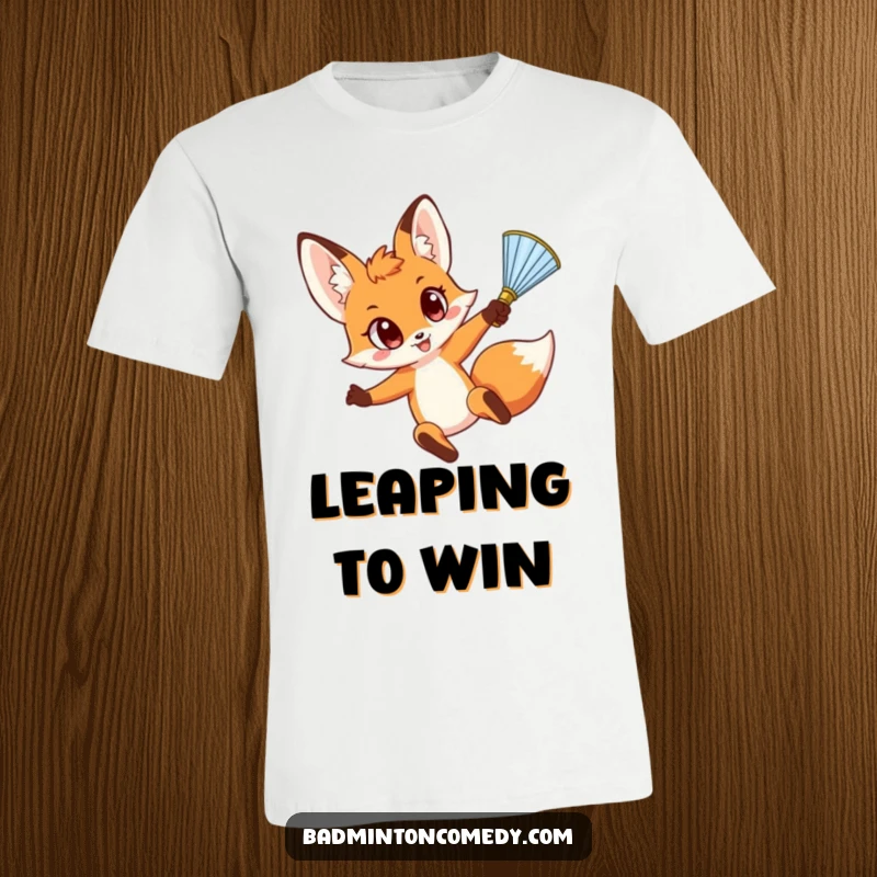 Funny Fox Smash T-Shirt: A whimsical fox with surprised wide eyes performs a dynamic leap to execute a powerful shuttlecock smash.