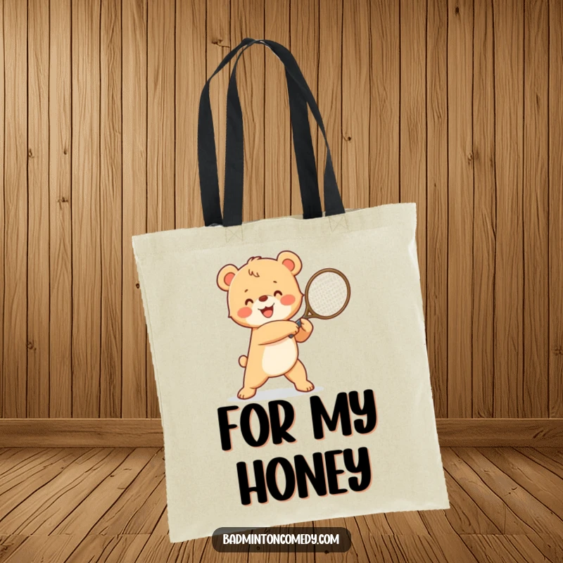 Funny happy bear cub, victoriously swinging a tennis racket, celebrating a win, a humorous and practical tote bag.