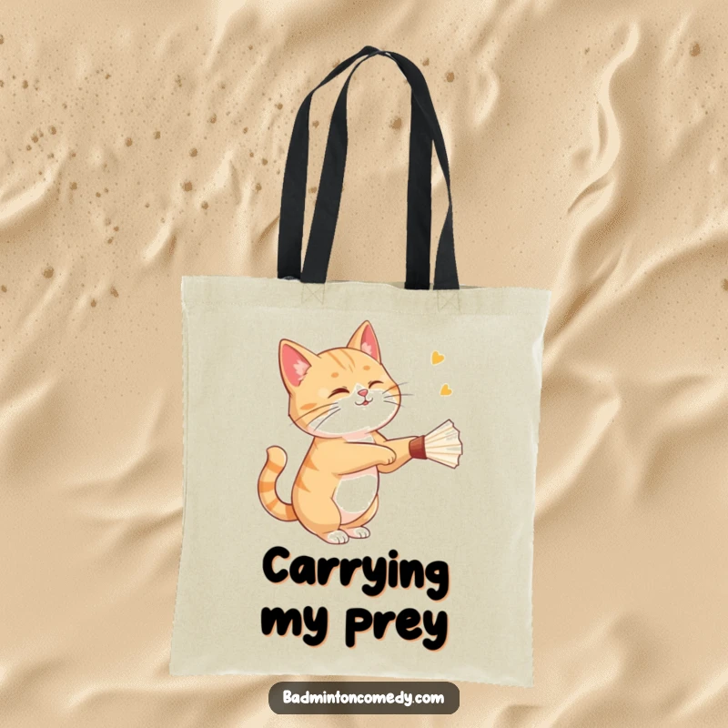 Funny cat gracefully striking a shuttlecock with a playful wink on this practical and humorous tote bag.