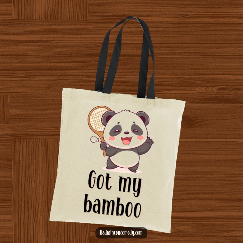 Funny smiling panda hitting a shuttlecock with a large racket, ready for action in this durable tote bag.