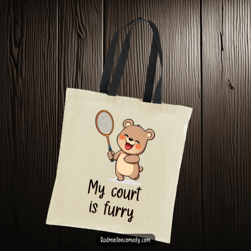 Funny bear character swinging a badminton racket with enthusiasm on a spacious tote bag, funny gift.